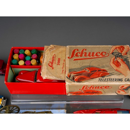 435 - A vintage boxed Schuco Telesteering tinplate clock work car with accessories together with boxed Gun... 