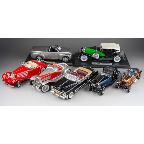 440 - A collection of seven die cast model cars, mainly 1:18 to include: mounted 1934 Duesenberg; Danbury ... 