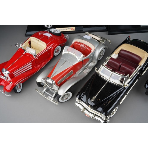 440 - A collection of seven die cast model cars, mainly 1:18 to include: mounted 1934 Duesenberg; Danbury ... 