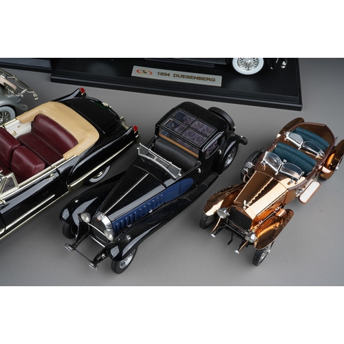 440 - A collection of seven die cast model cars, mainly 1:18 to include: mounted 1934 Duesenberg; Danbury ... 