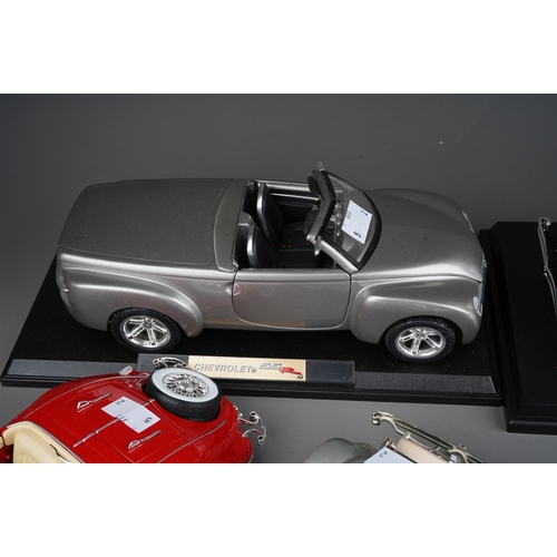 440 - A collection of seven die cast model cars, mainly 1:18 to include: mounted 1934 Duesenberg; Danbury ... 