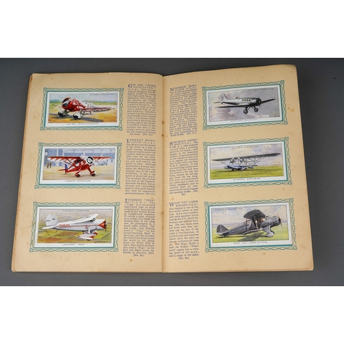 458 - Four 1930s cigaratte card albums to include: John Player & Sons Motor Cars (1st and 2nd Series)  and... 