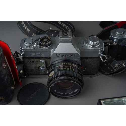 496 - A collection of Canon cameras and lenses including Canon AV-1 camera with 35 - 70mm / F3.5/4.5 lens,... 