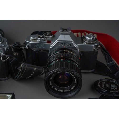 496 - A collection of Canon cameras and lenses including Canon AV-1 camera with 35 - 70mm / F3.5/4.5 lens,... 