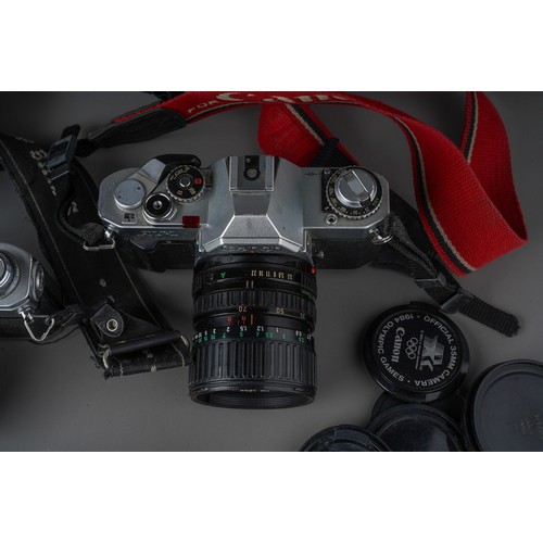 496 - A collection of Canon cameras and lenses including Canon AV-1 camera with 35 - 70mm / F3.5/4.5 lens,... 