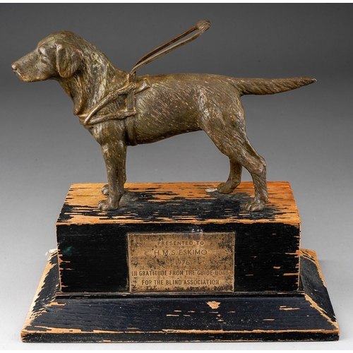 502 - A Modern presentation patinated metal cast of a guide dog with harness on ebonised plinth with plaqu... 