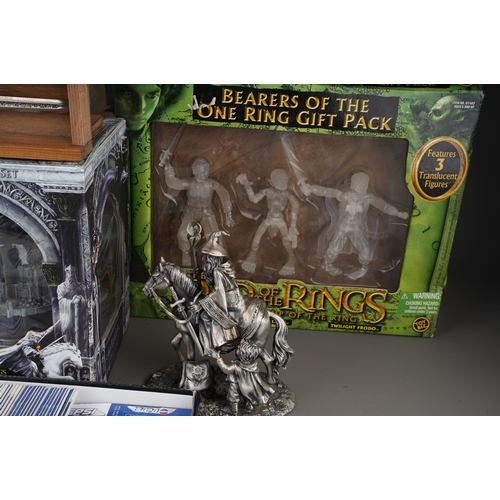 524 - A collection of Lord of the Rings memorabilia, including a pewter figure group of Gandalf and Frodo,... 