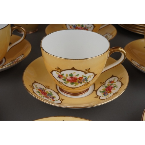 541 - A Crown Chelsea China tea set, apricot ground with printed and painted panels of flowers, comprising... 