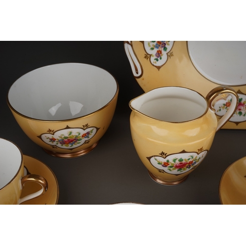 541 - A Crown Chelsea China tea set, apricot ground with printed and painted panels of flowers, comprising... 