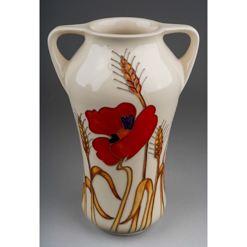 574 - A Moorcroft Poppy and wheat sheaf two handled vase, on cream ground, designed in 2009, backstamp and... 