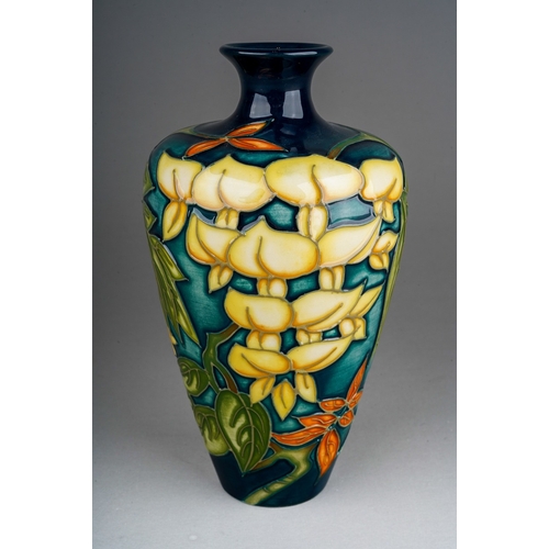 591 - A boxed Moorcroft pottery Collectors Club baluster vase in a Wisteria design, by Philip Gibson, circ... 