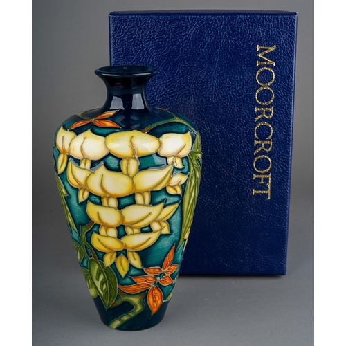 591 - A boxed Moorcroft pottery Collectors Club baluster vase in a Wisteria design, by Philip Gibson, circ... 