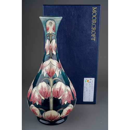 595 - A Moorcroft pottery onion shaped vase in a design trial Desert Orchid design by Anji Davenport, insc... 