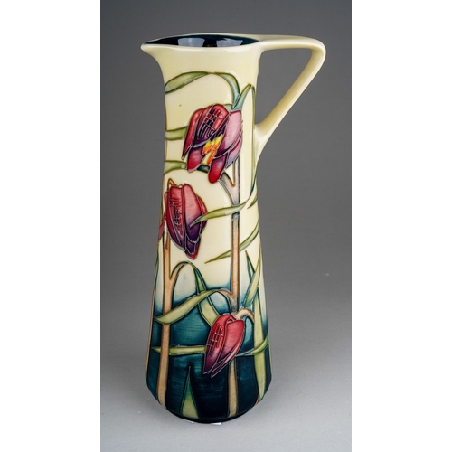 599 - A boxed Moorcroft pottery conical jug in the Cricklade design  bears Philip Gibson's signature and d... 