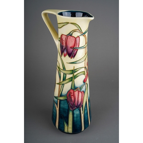 599 - A boxed Moorcroft pottery conical jug in the Cricklade design  bears Philip Gibson's signature and d... 