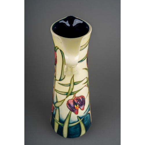 599 - A boxed Moorcroft pottery conical jug in the Cricklade design  bears Philip Gibson's signature and d... 