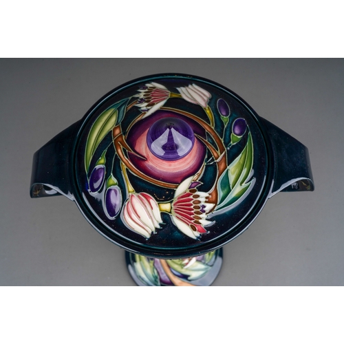 607 - A Moorcroft pottery Collectors Club  twin handled bonbonniere and cover decorated in the Symphony de... 