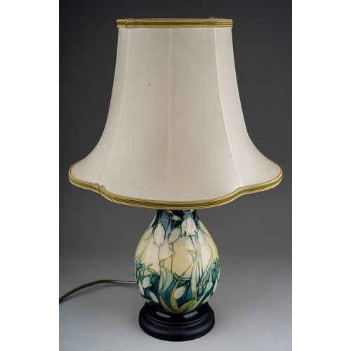 609 - A Moorcroft pottery baluster table lamp decorated in the Nivalis Snowdrops design, mounted on a wood... 