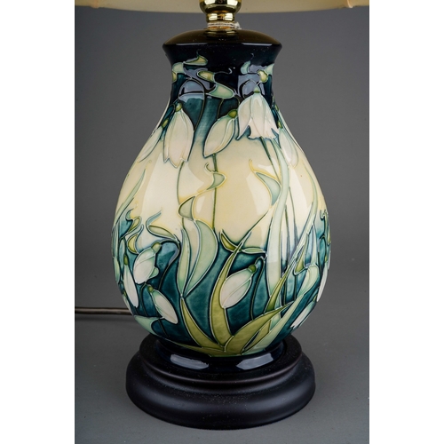 609 - A Moorcroft pottery baluster table lamp decorated in the Nivalis Snowdrops design, mounted on a wood... 