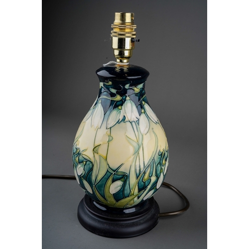 609 - A Moorcroft pottery baluster table lamp decorated in the Nivalis Snowdrops design, mounted on a wood... 