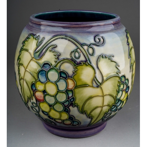 610 - A Moorcroft pottery globular vase decorated with a design of bunches of grapes, initialled DCH and d... 