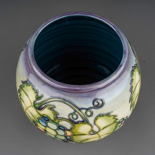 610 - A Moorcroft pottery globular vase decorated with a design of bunches of grapes, initialled DCH and d... 