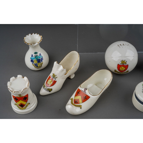 619 - A small quantity of crested china Souvenir ware including top hats, shoes, teapots, cheese cover etc... 