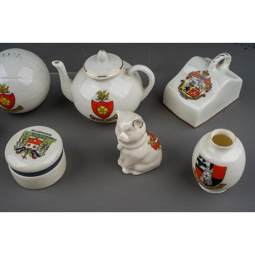 619 - A small quantity of crested china Souvenir ware including top hats, shoes, teapots, cheese cover etc... 