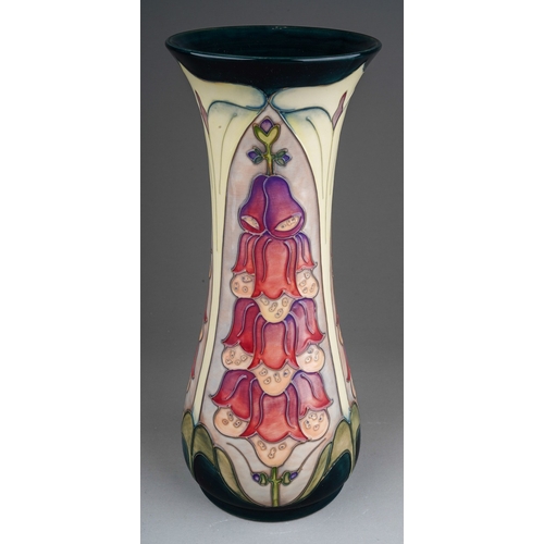 624 - A boxed Moorcroft baluster vase in the Foxglove design by Rachel Bishop, a second, painted and impre... 