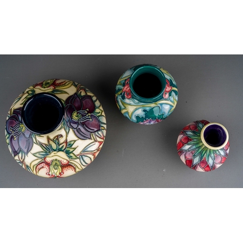 629 - Three piece of  Moorcroft pottery, comprising a squat baluster vase decorated in the Hellebore desig... 