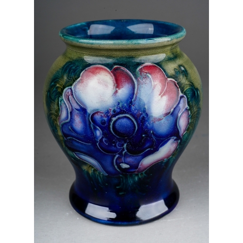 630 - A William Moorcroft small baluster vase decorated in an Anemone design on a blue and green ground, i... 