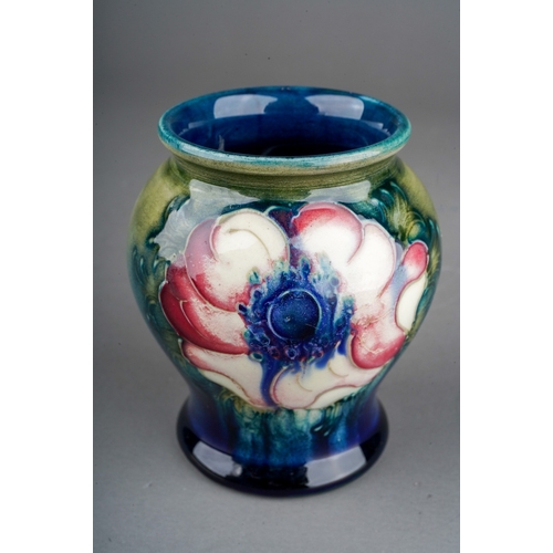 630 - A William Moorcroft small baluster vase decorated in an Anemone design on a blue and green ground, i... 