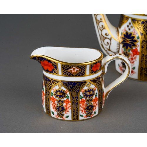 637 - A boxed Royal Crown Derby Imari 1128 pattern miniature five piece tea set and oval tray, the tea set... 