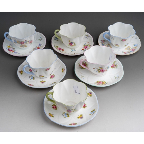 639 - A set of six Shelley breakfast cups and saucers, pattern no 13240, decorated with flowers, harlequin... 