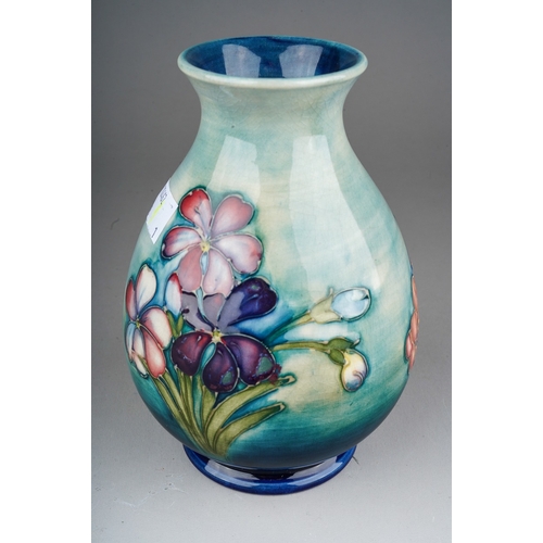 646 - A William Moorcroft pottery baluster vase decorated in the Spring Flowers design, painted signature ... 