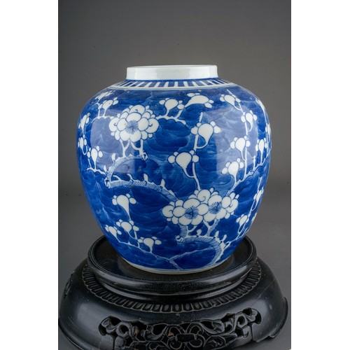 657 - A Chinese blue and white ginger jar and cover, decorated with prunus blossom, concentric circles to ... 