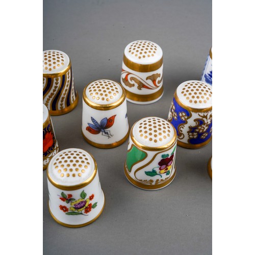 661 - A collection of Royal Crown Derby to include: fifteen thimbles  and a floral bocage brooch.