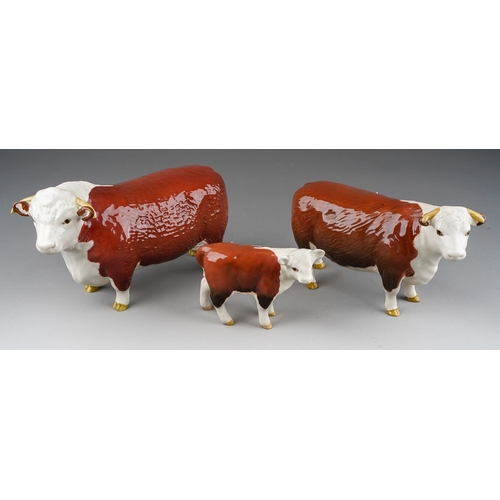 703 - A Beswick Champion of Champions Bull and Cow together with a Hereford calf, all stamped (3)