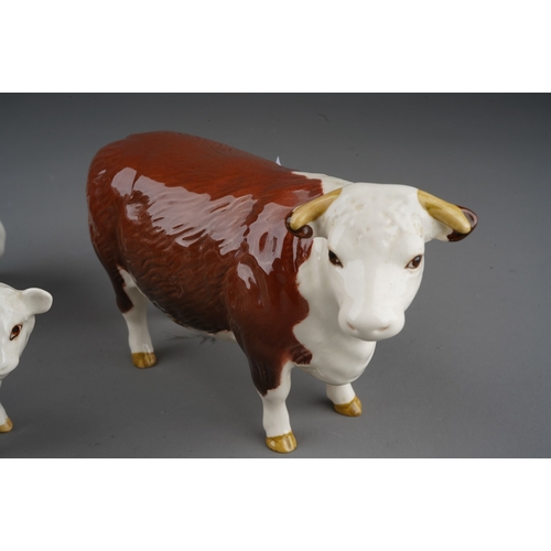 703 - A Beswick Champion of Champions Bull and Cow together with a Hereford calf, all stamped (3)