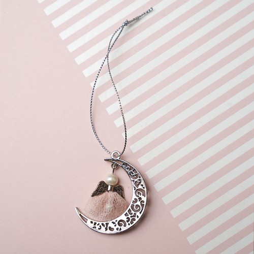 737 - An Angel charm attached to a metal moon, made using the lace from Lisa Snowdon’s peach bra and silve... 