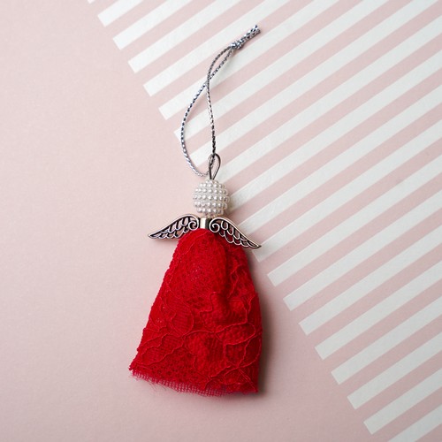 740 - An Angel charm made using the lace from Lisa Snowdon’s red bra and silver metal findings.
Approx siz... 