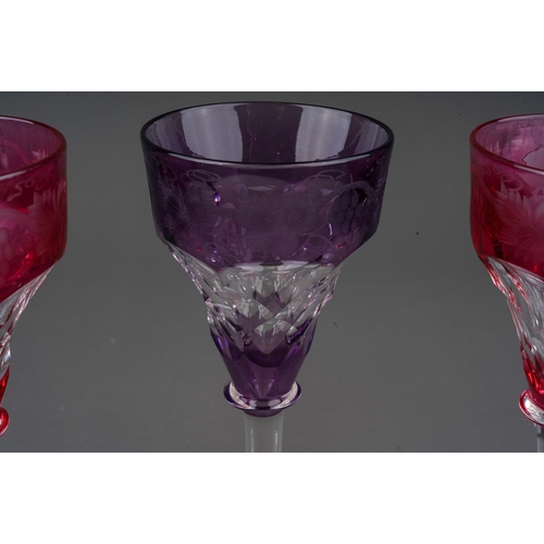 792 - Three John Walsh coloured crystal ogee shaped wine glass with vine leaf and grapes etched border, 2 ... 