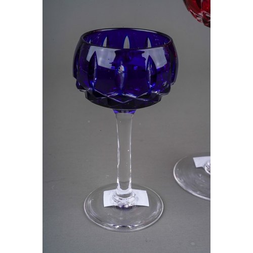 793 - Four John Walsh coloured cut glass wine and port glasses, amethyst, ruby x 2 and cobalt) on clear st... 