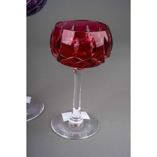 793 - Four John Walsh coloured cut glass wine and port glasses, amethyst, ruby x 2 and cobalt) on clear st... 