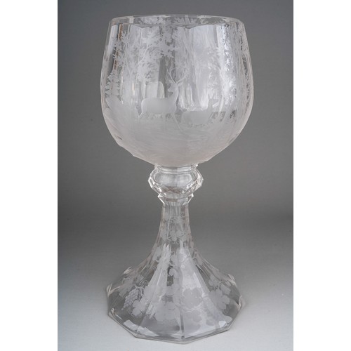 804 - A large Bohemian Biedermeier style facet cut large etched glass goblet decorated with deers in woodl... 