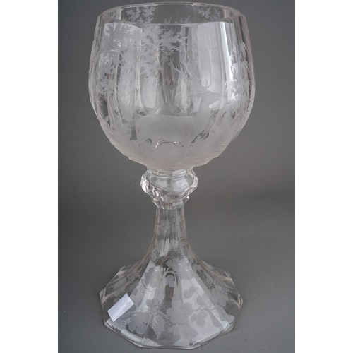 804 - A large Bohemian Biedermeier style facet cut large etched glass goblet decorated with deers in woodl... 