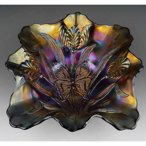 806 - An early 20th century American purple carnival glass dish in the Butterfly and Tulip pattern, produc... 