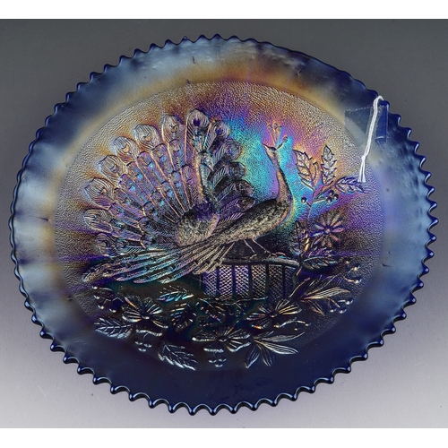 807 - An early 20th century American blue carnival glass dish decorated in the Peacocks on the Fence patte... 