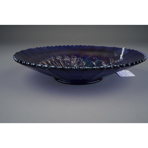 807 - An early 20th century American blue carnival glass dish decorated in the Peacocks on the Fence patte... 