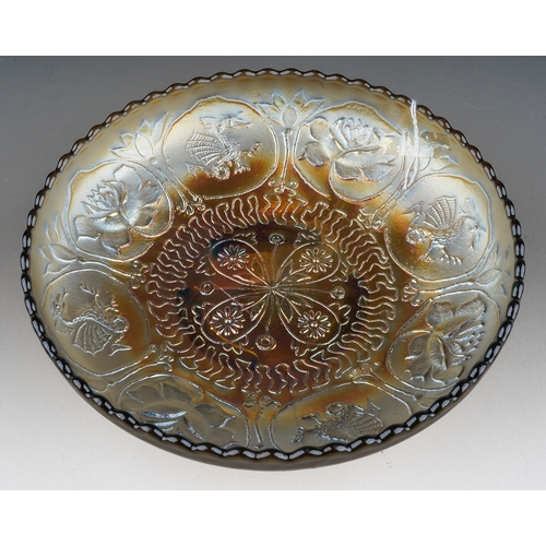 808 - An early 20th Century American smoke Carnival glass footed bowl, by Fenton, relief moulded to the in... 